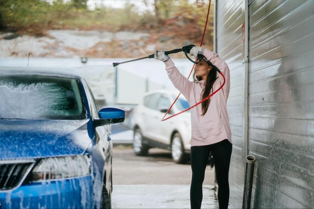 Woman washing a car