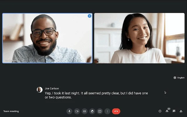 Google Meet showing an active meeting with two participants and the live caption turned on.