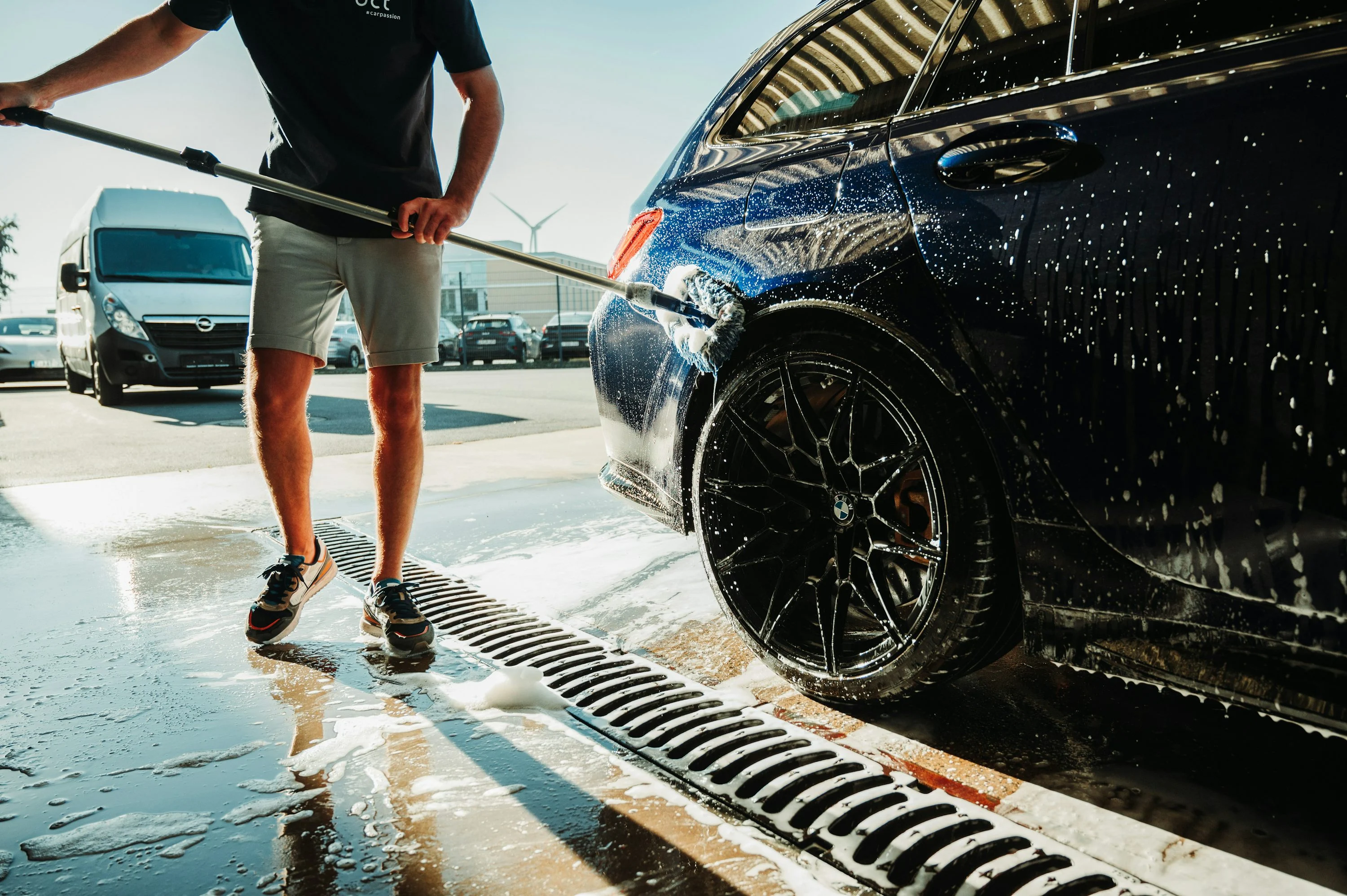 A man washing a car with a hose