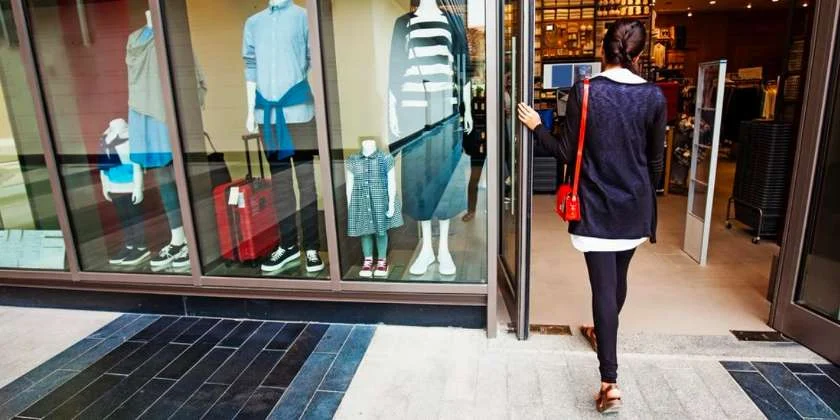 Showing a woman walking inside a store.