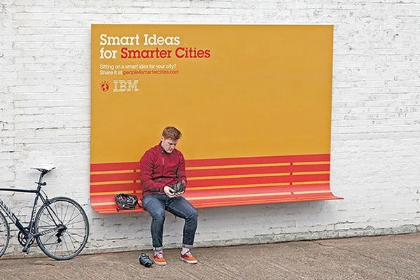 A billboard ad from IBM that incorporates a bench passersby can sit on.