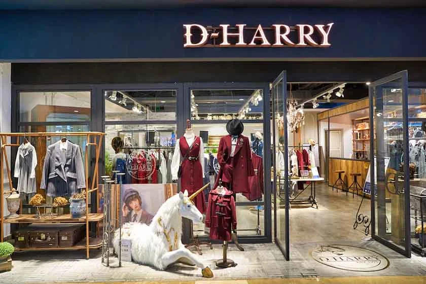 Beautiful clothes in modern fashion shop.