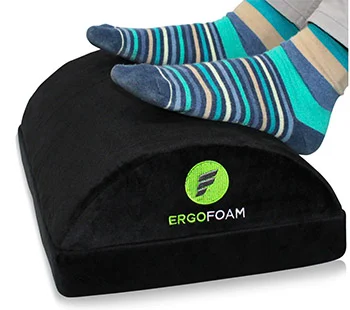 Ergofoam Adjustable footrest with feet in striped socks on top.