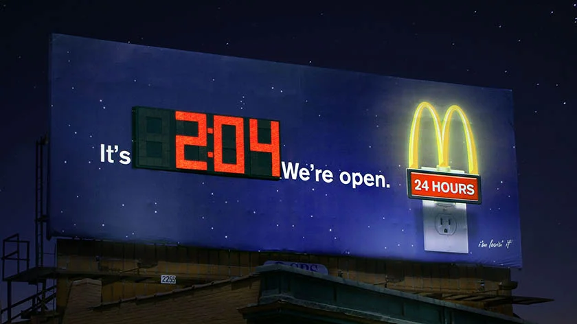 A billboard ad from McDonald's displaying the current time to promote its 24-hour services.