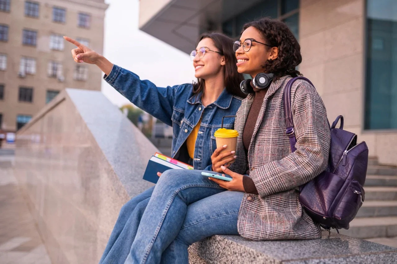Two college girls on campus. photo by u_7csqbq4k4j on Pixabay.