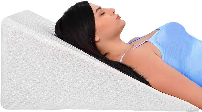 Woman lying on a wedge pillow.