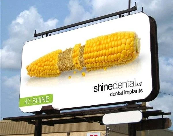 A billboard from a dental clinic using humor to promote dental implants.