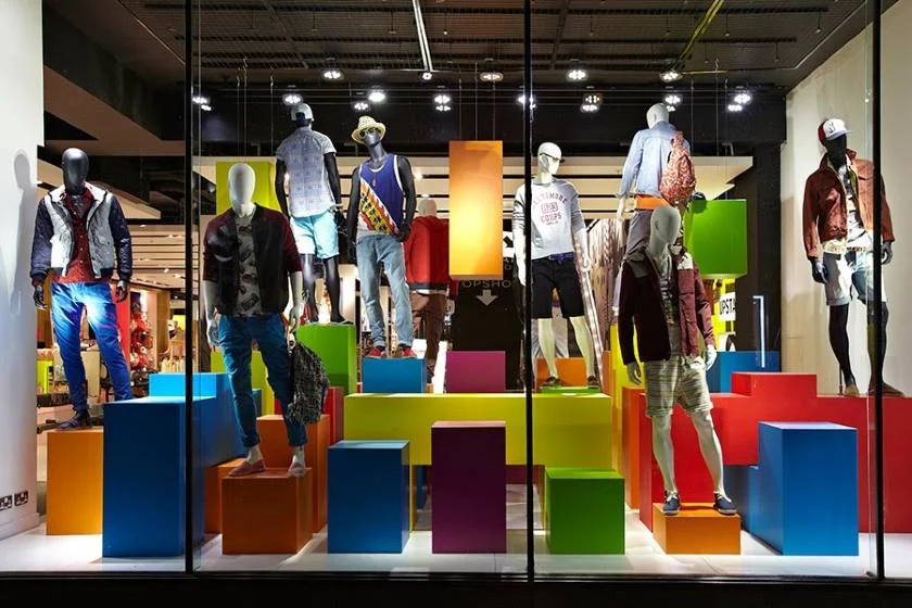 Showing a store window men's outfit display.